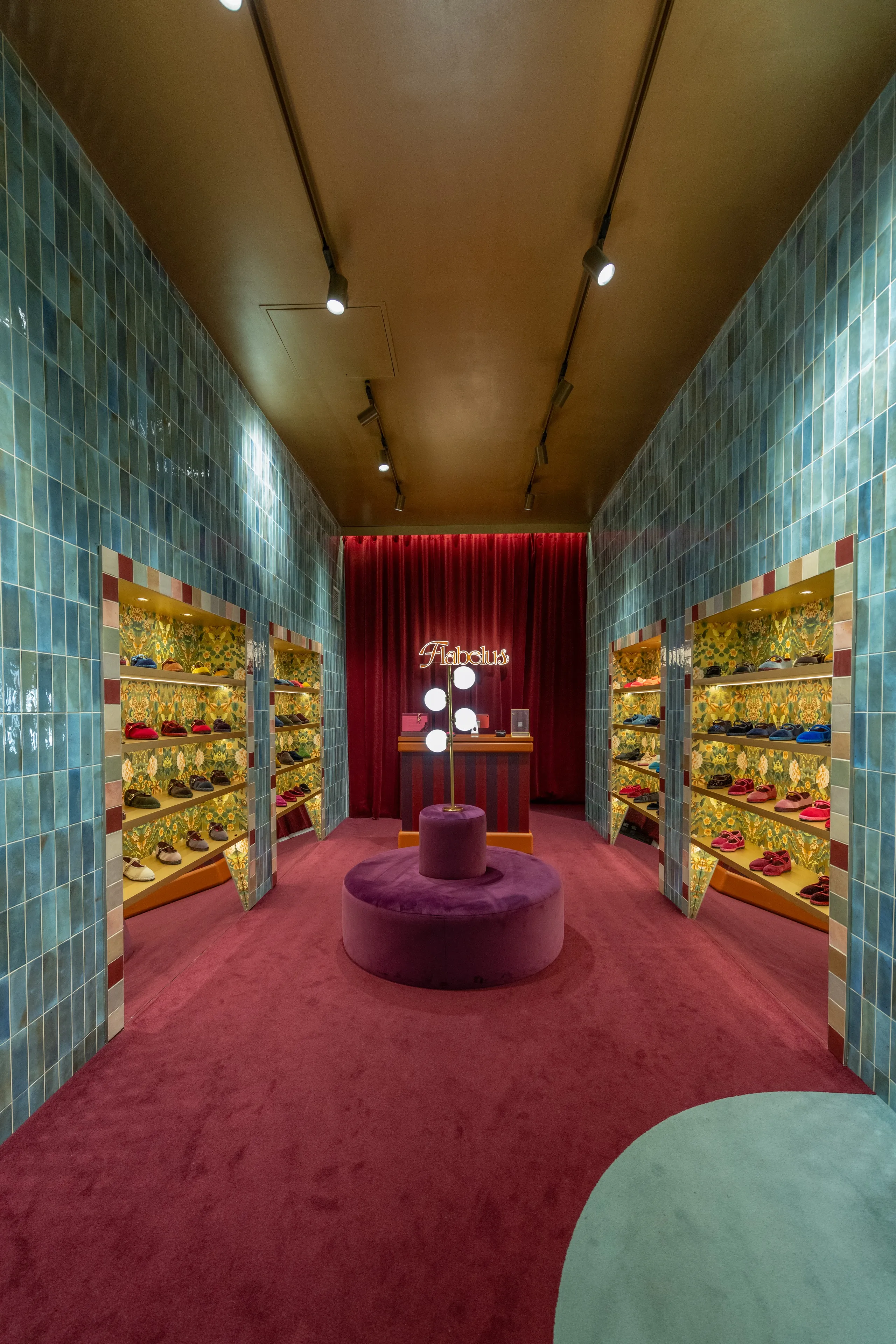 Flabelus shoe store with tiled walls, pink seating and turquoise shelving