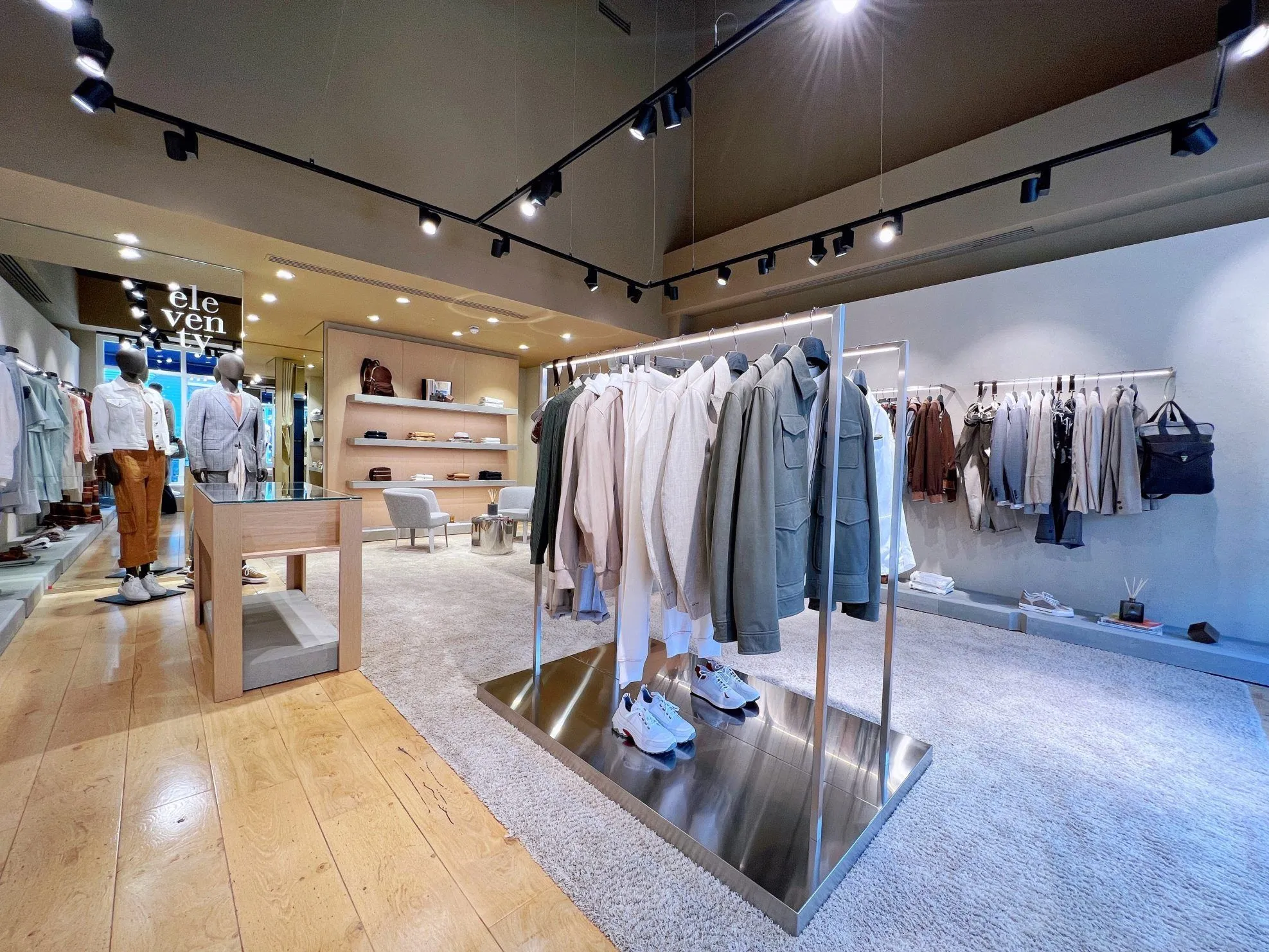 Eleventy store with clothing rails, steel plinths and oak display units