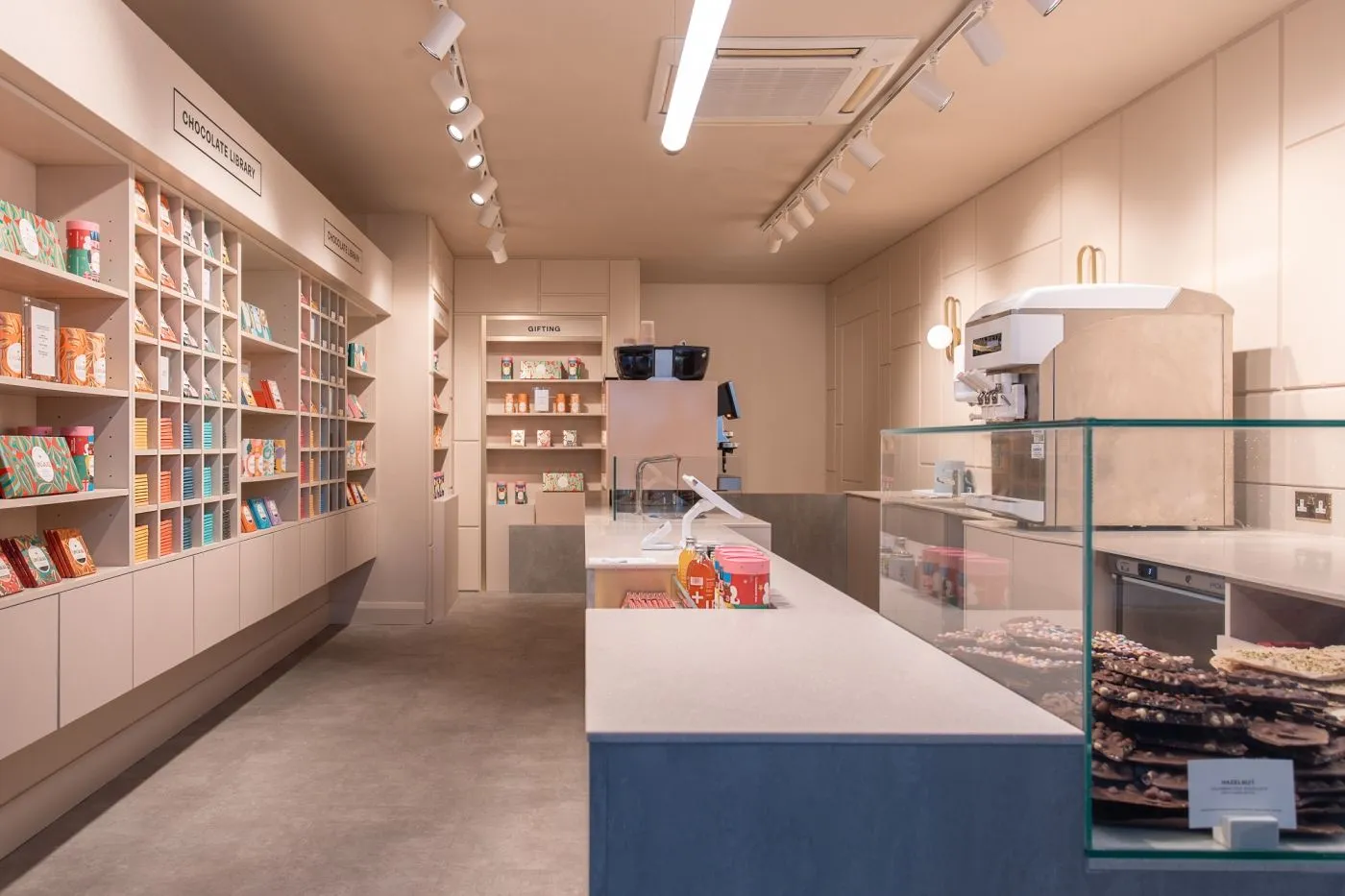 Love Cocoa shop interior with pastel chocolate shelving and a serving counter