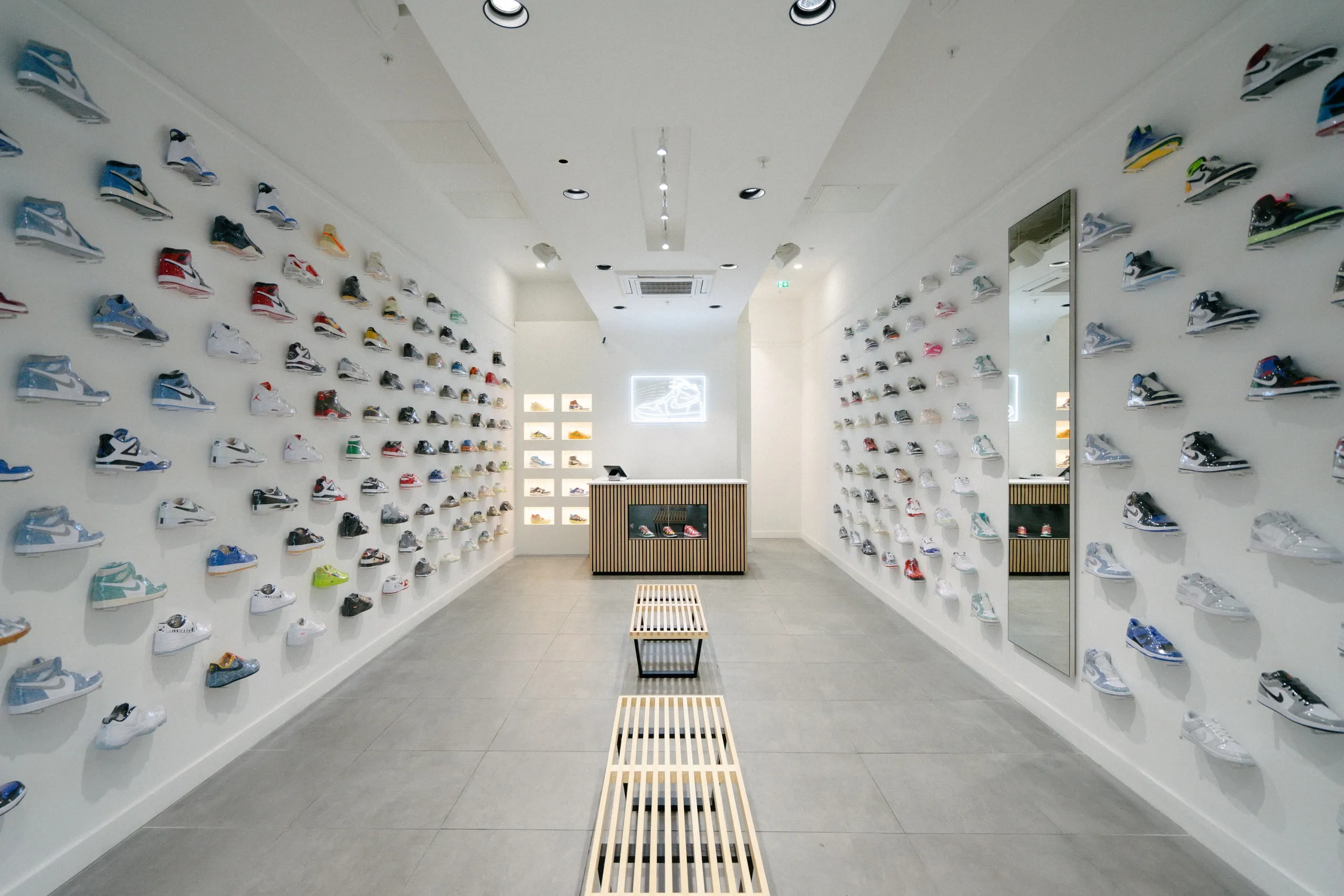 Kick Game store with trainers on floating shelves along both walls