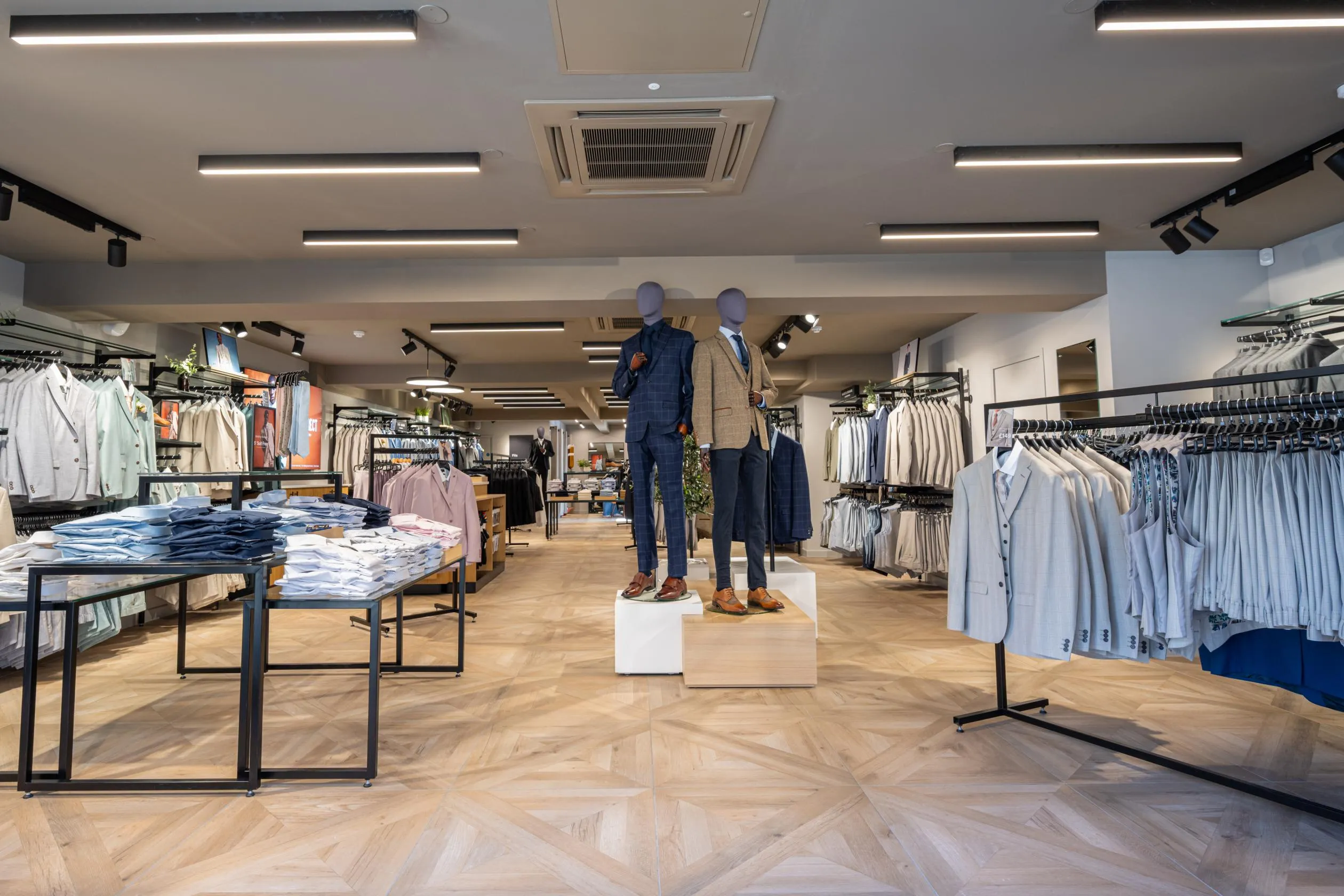 Suit Direct menswear floor with mannequins, steel rails and parquet floor