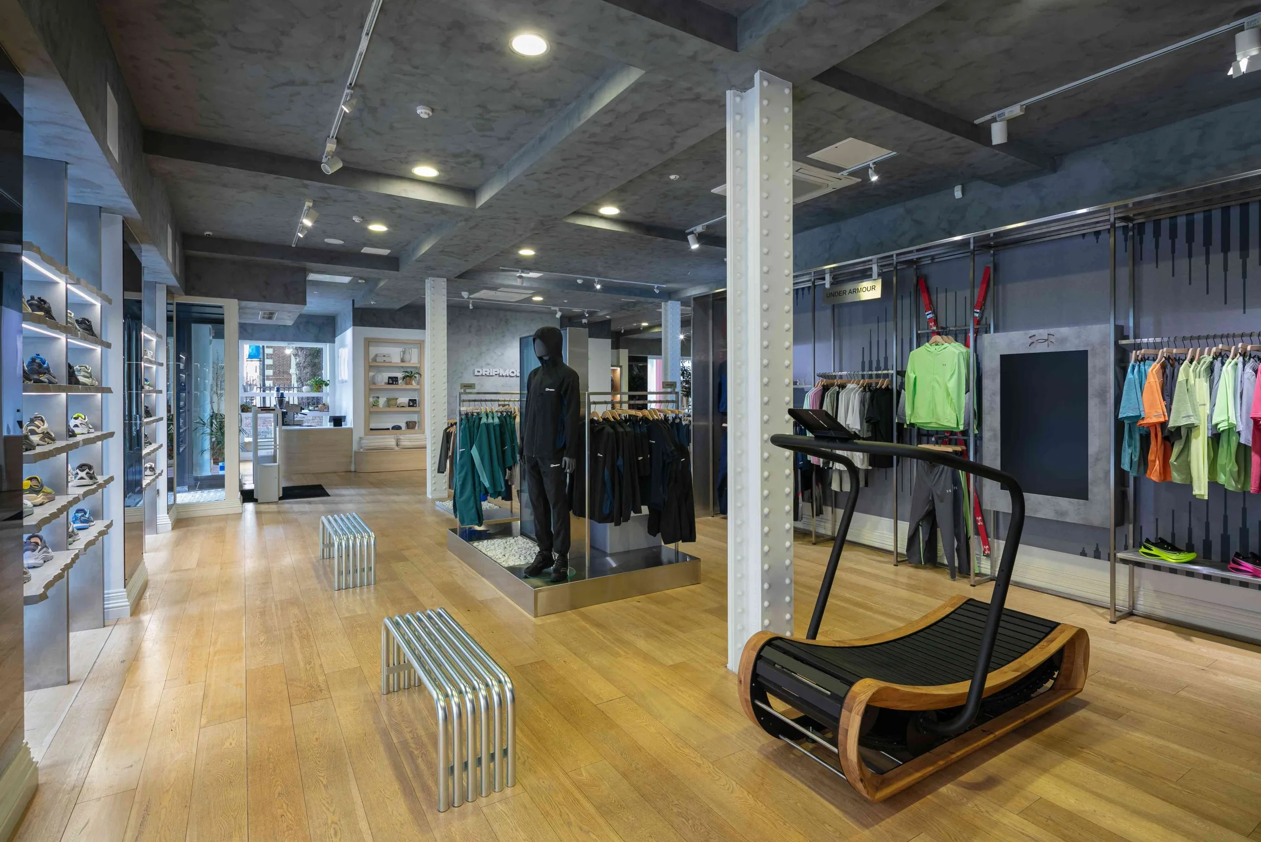Drip Moda store with curved treadmill display, footwear wall and sportswear rails