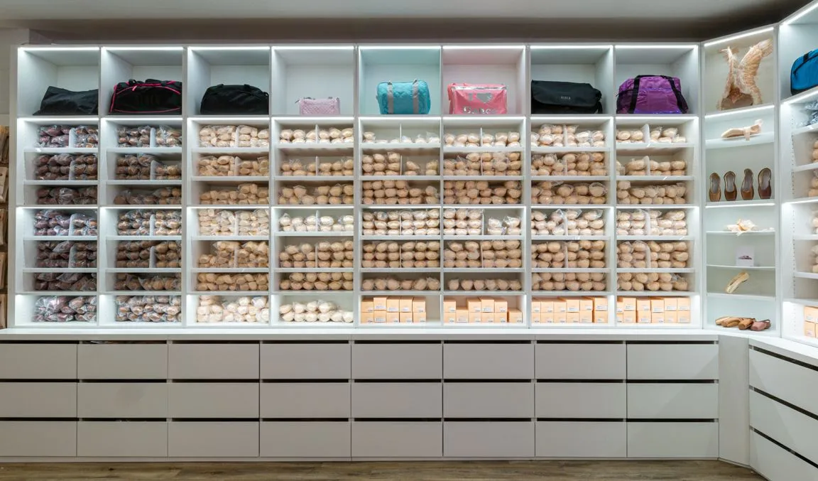 Bloch pointe shoe wall of white illuminated pigeonholes