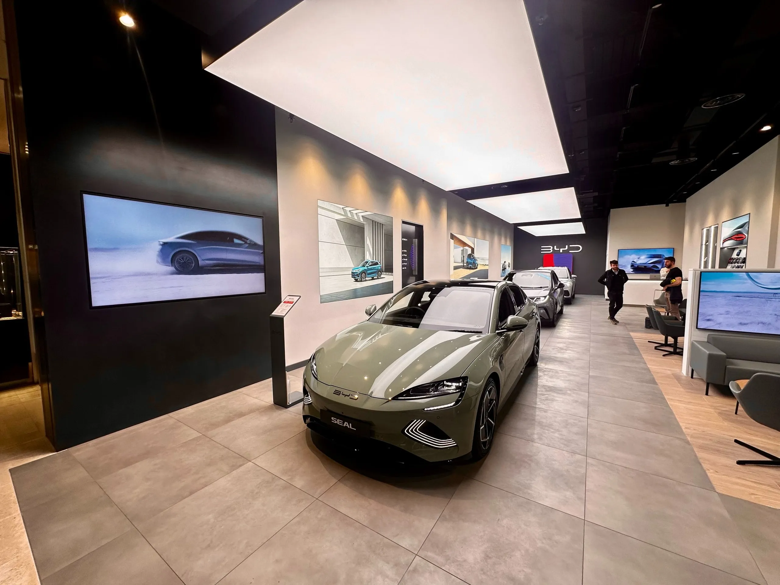 BYD showroom with an electric saloon under a large lightbox ceiling