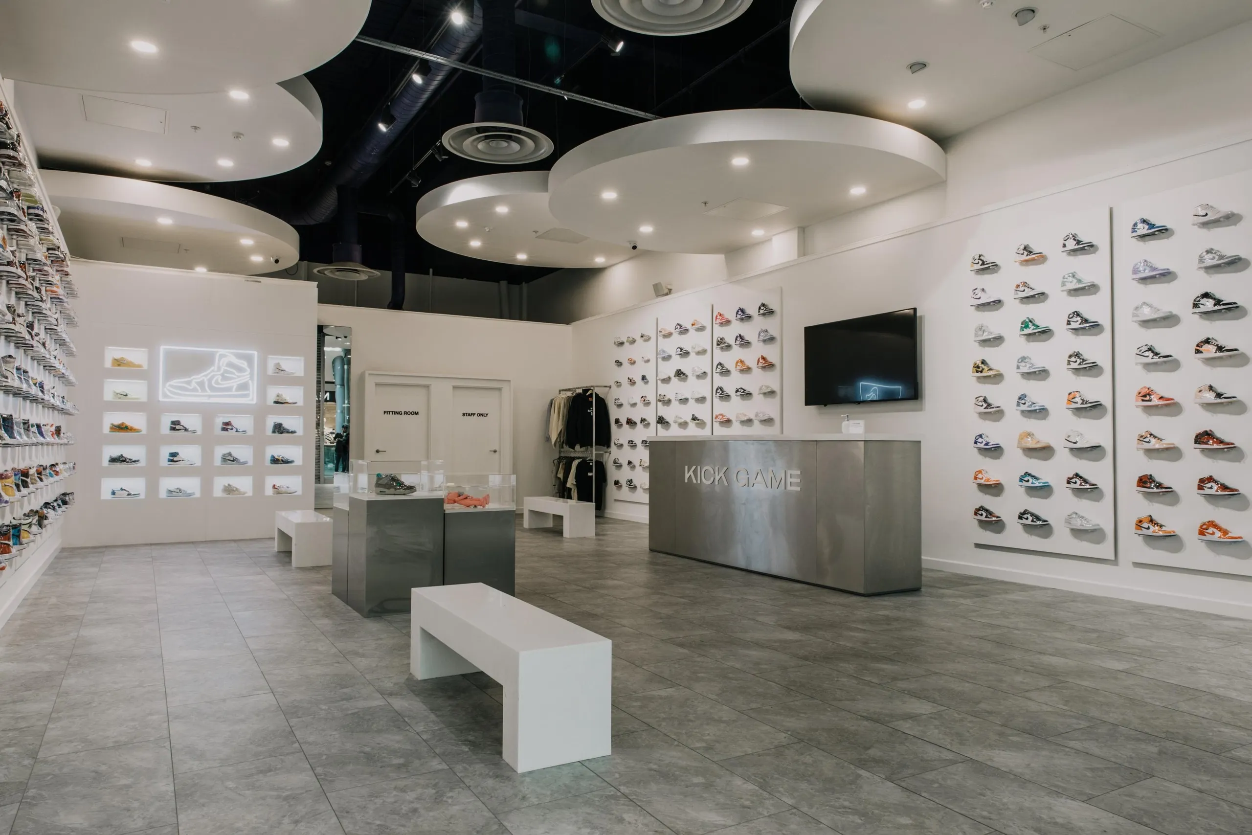 Kick Game store with trainer walls, circular ceiling rafts and a steel counter